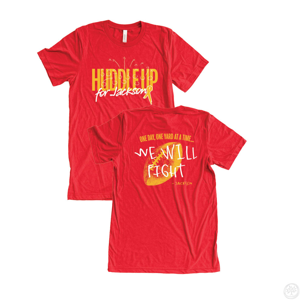 Red short sleeve shirt with football theme, front text reading “Huddle Up for Jackson” and back text “One day, one yard at a time… We Will Fight – Jackson” – pediatric illness support tee.