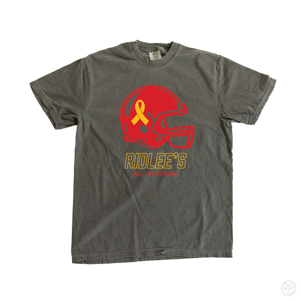 Charcoal t-shirt featuring a large red football helmet with yellow awareness ribbon and gold block text reading “Ridlee’s All-Star Team” – custom medical support shirt for pediatric illness or sports-themed fundraiser. Childhood cancer