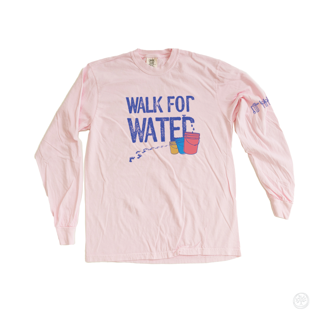 Light pink long sleeve t-shirt with bold blue and pink text reading “Walk for Water” and bucket illustrations – nonprofit event shirt promoting clean water access initiatives globally.