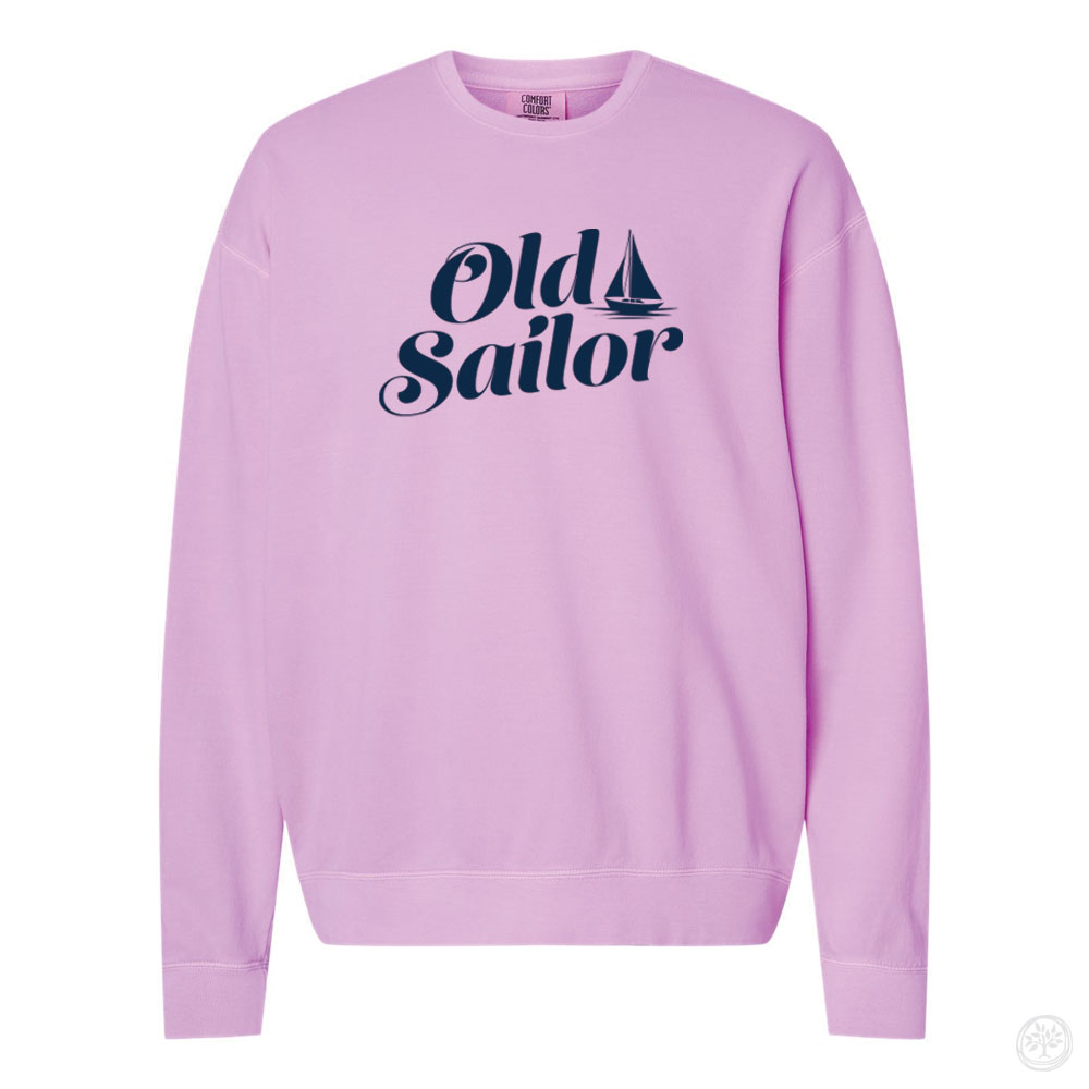Old Sailor Crewneck (Pink) Alt Text: Light pink crewneck sweatshirt with dark navy blue vintage-style text reading “Old Sailor” with a sailboat icon.