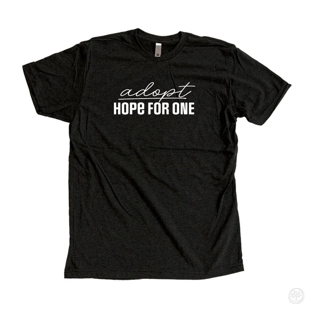 "adopt HOPE FOR ONE" tee (black): Black t-shirt with white text that reads "adopt HOPE FOR ONE" in a clean and simple design.